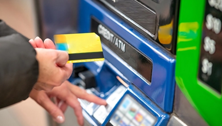 customer putting a credit card into an atm