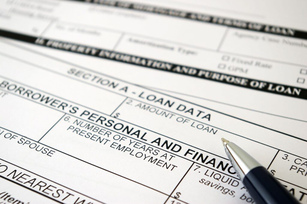close up image of a loan application with a pen laying flat on the loan application.